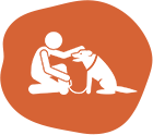 A person sitting on the ground with a dog.